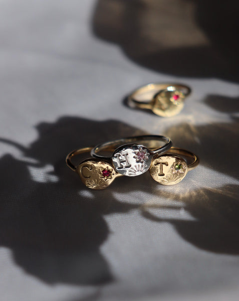 Sun and star initial ring with birthstone